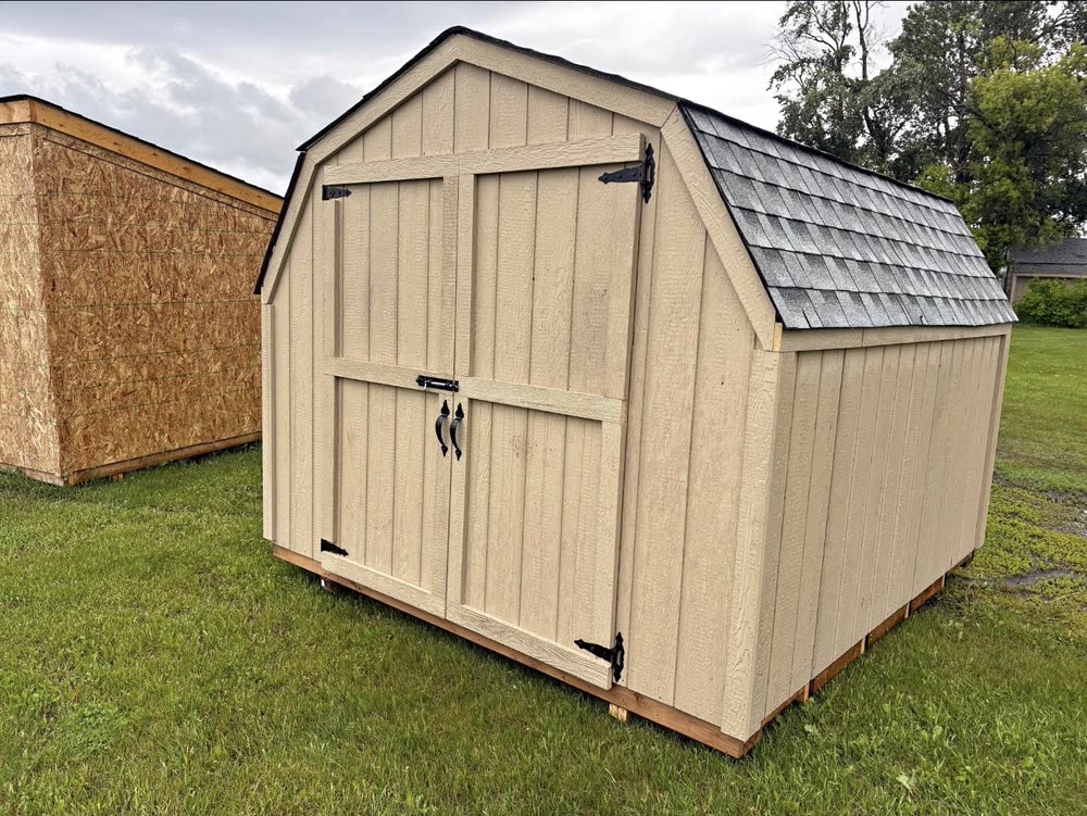 A painted Apex barn shed with wood barn doors
